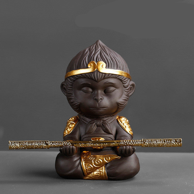 Statue of a monkey holding a sword on a gray background