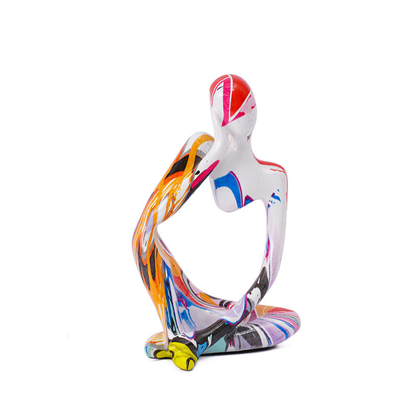 Minimalist colorful resin sculpture of three seated figures for modern home décor
